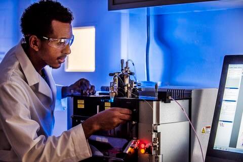 researcher adjusting equipment